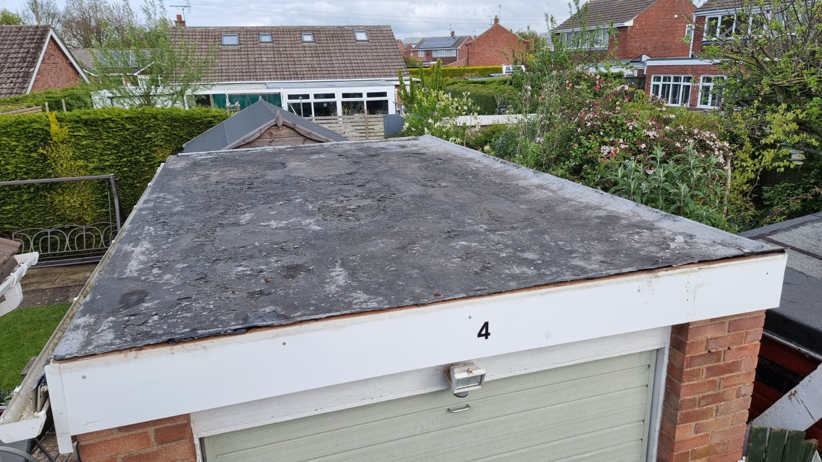 Garage roof before replacement showing worn felt