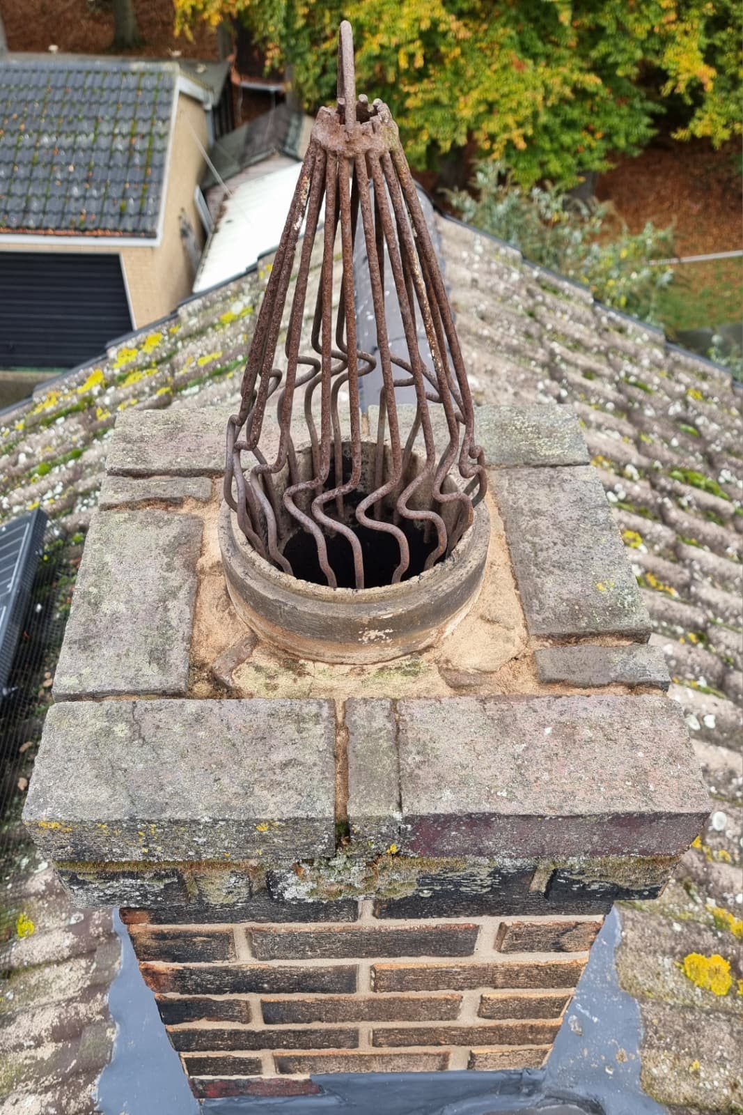 Repointed brick chimney stack with new capping and cowl fitted