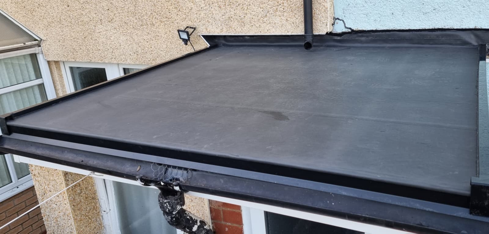 Completed EPDM rubber flat roof with new guttering