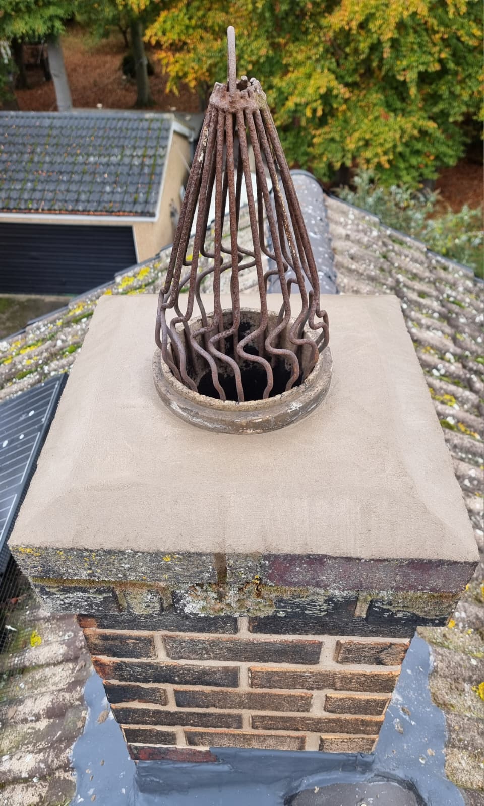 Chimney pot with bird guard cage before restoration work