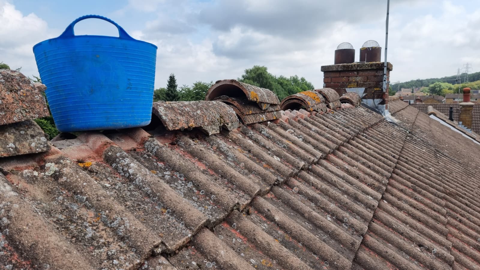 Pitched roof with chimney and surrounding neighbourhood view
