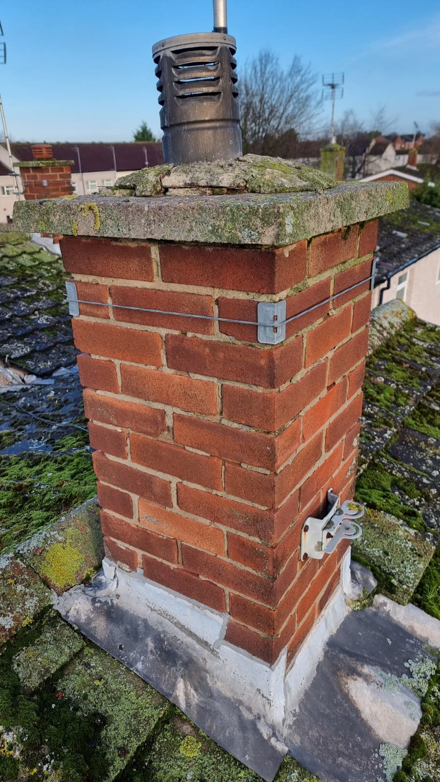 Freshly rendered chimney crown with bird guard installed