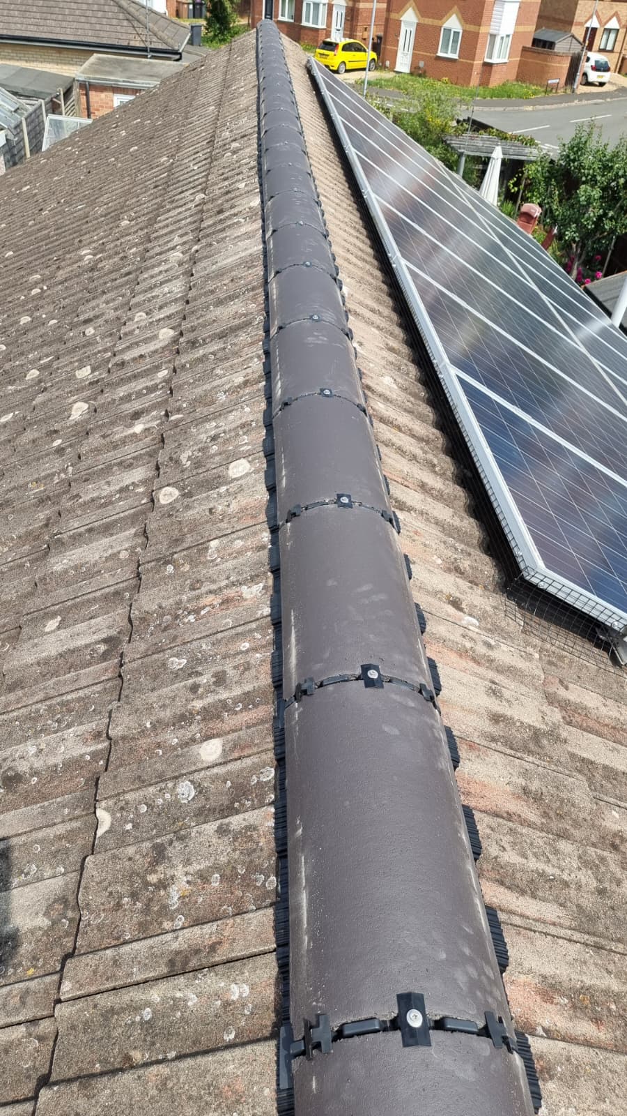 Completed dark dry ridge tiles fitted with clips