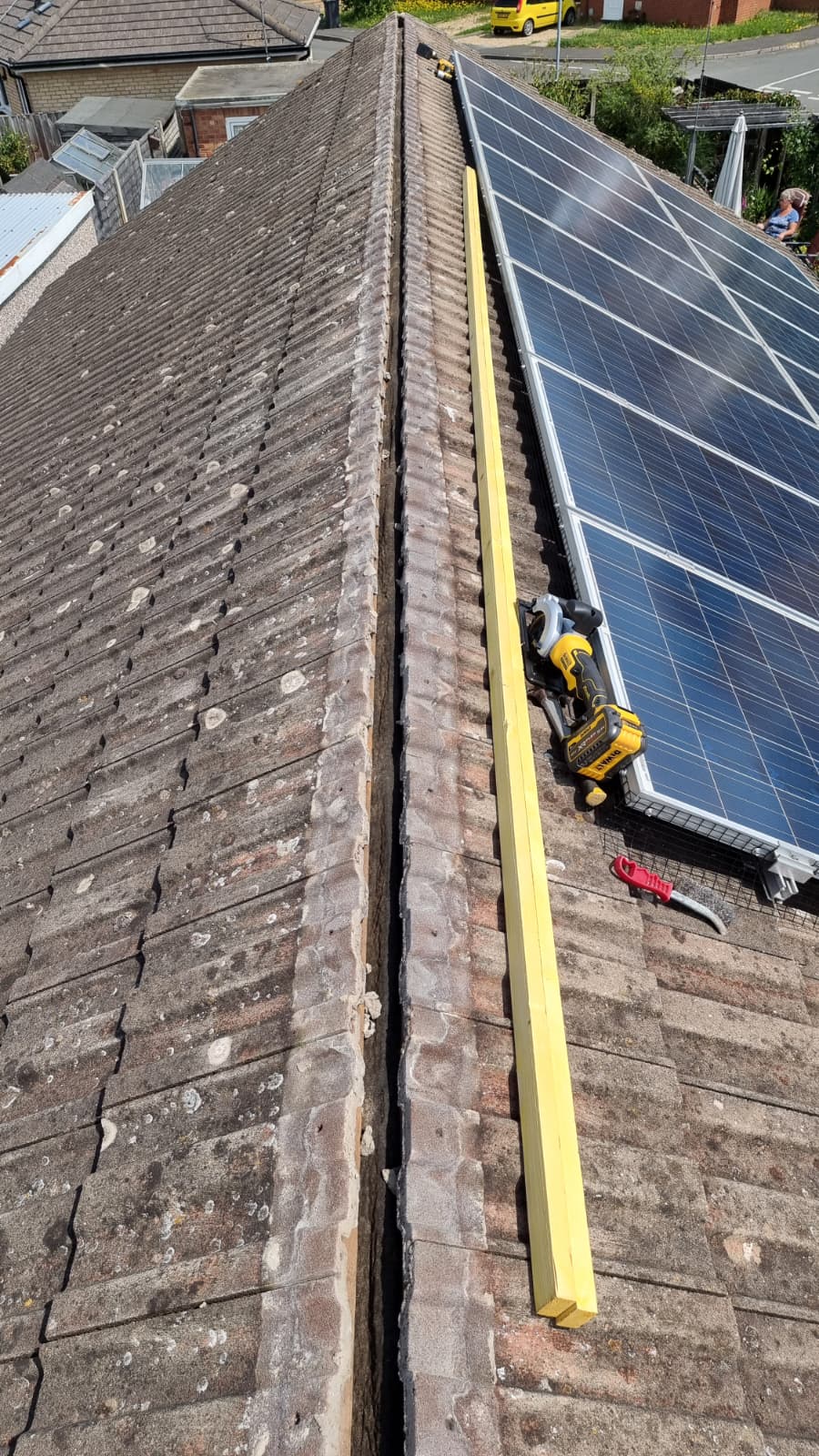Ridge preparation with new batten and drill alongside solar panels