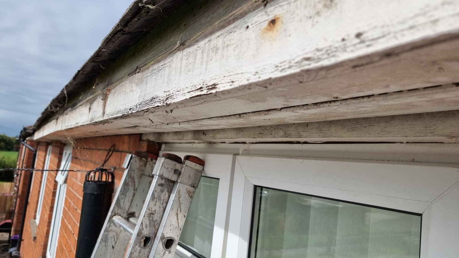 Guttering and downpipe installation on terraced house
