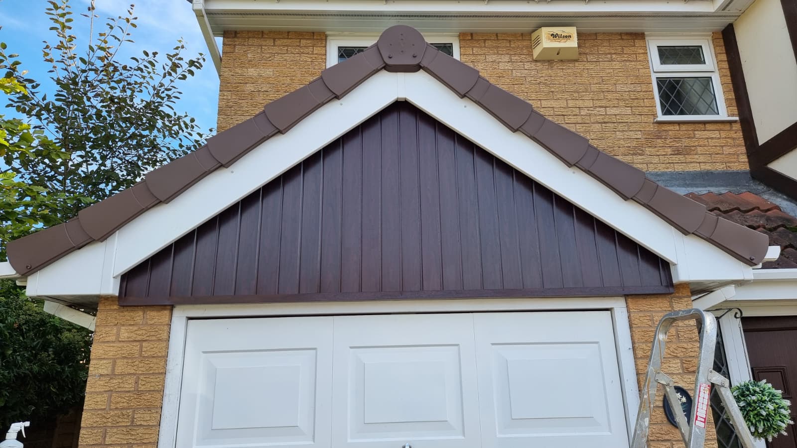 New brown cladding and fascias fitted to garage gable end