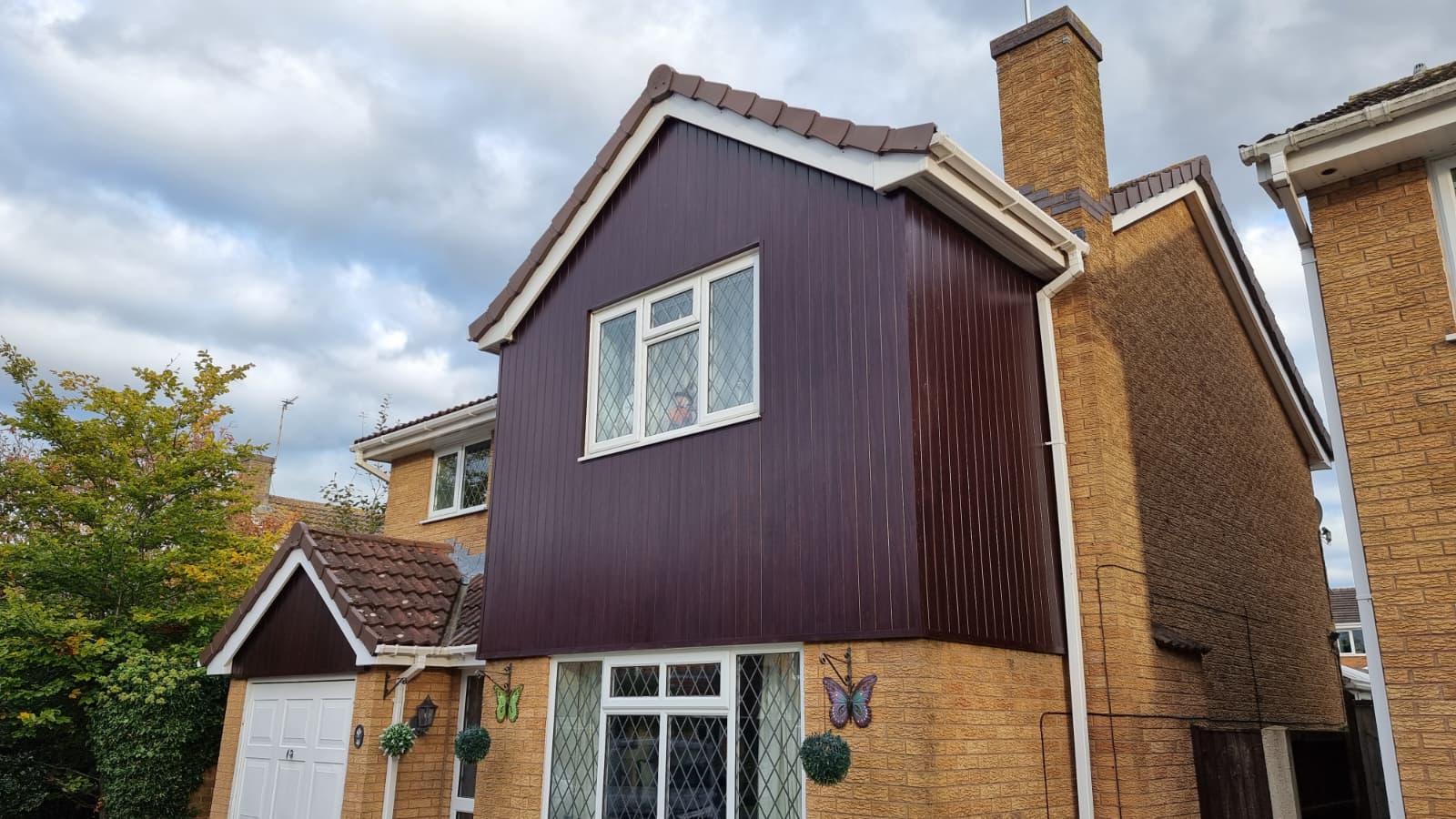 Full cladding replacement on detached house with brown panels