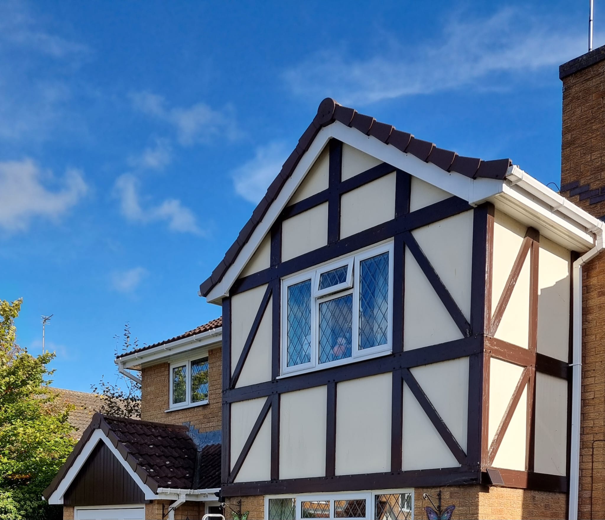 Tudor-style house with new fascias and cladding