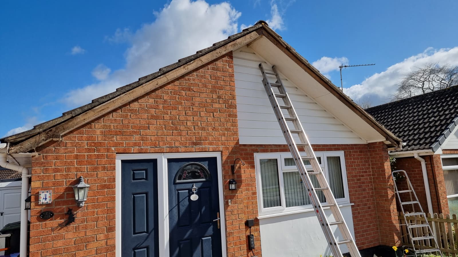 Bungalow before fascia and cladding work with ladder access
