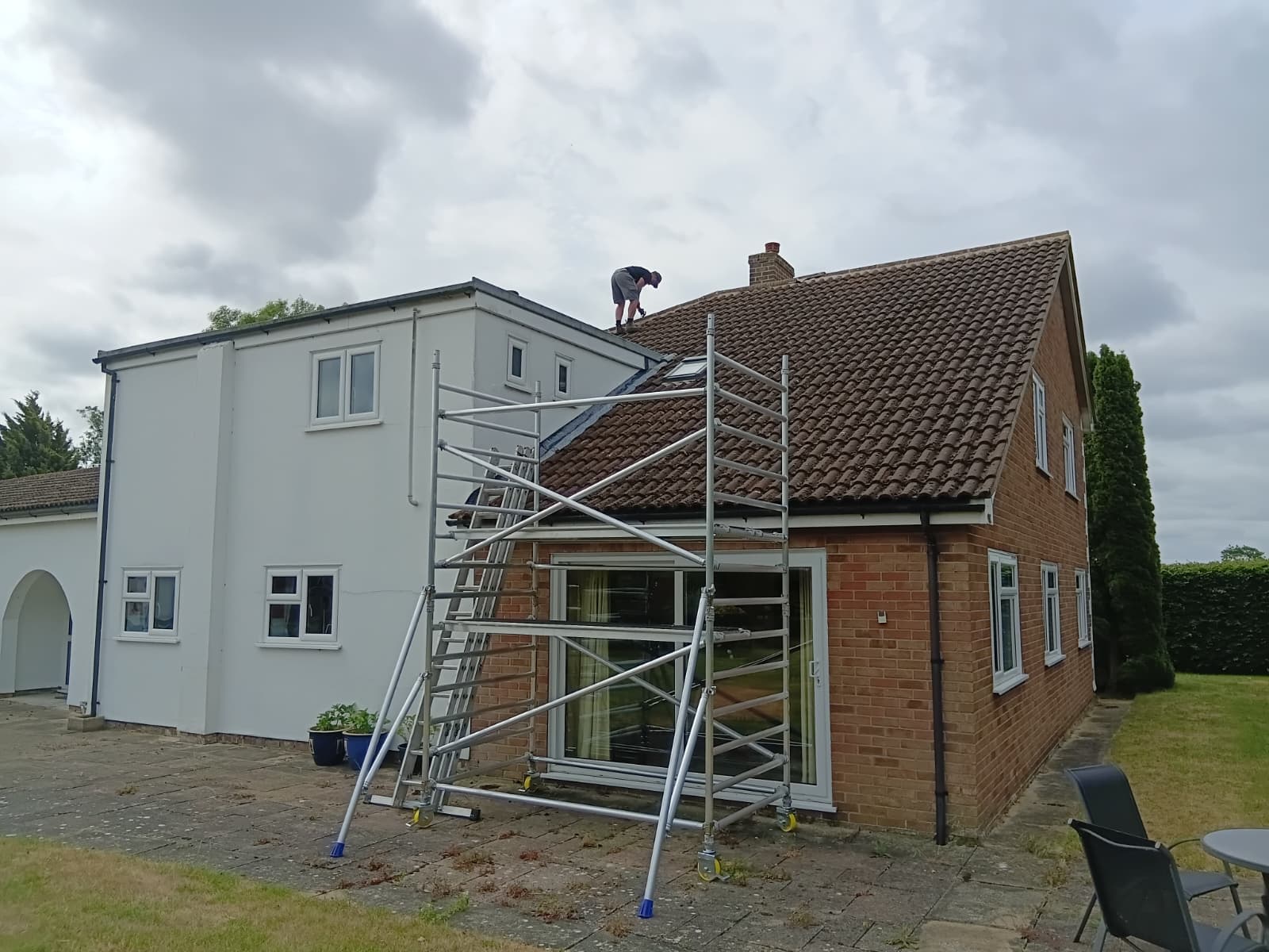 Torn and perished old felt underlay exposed before full roof replacement