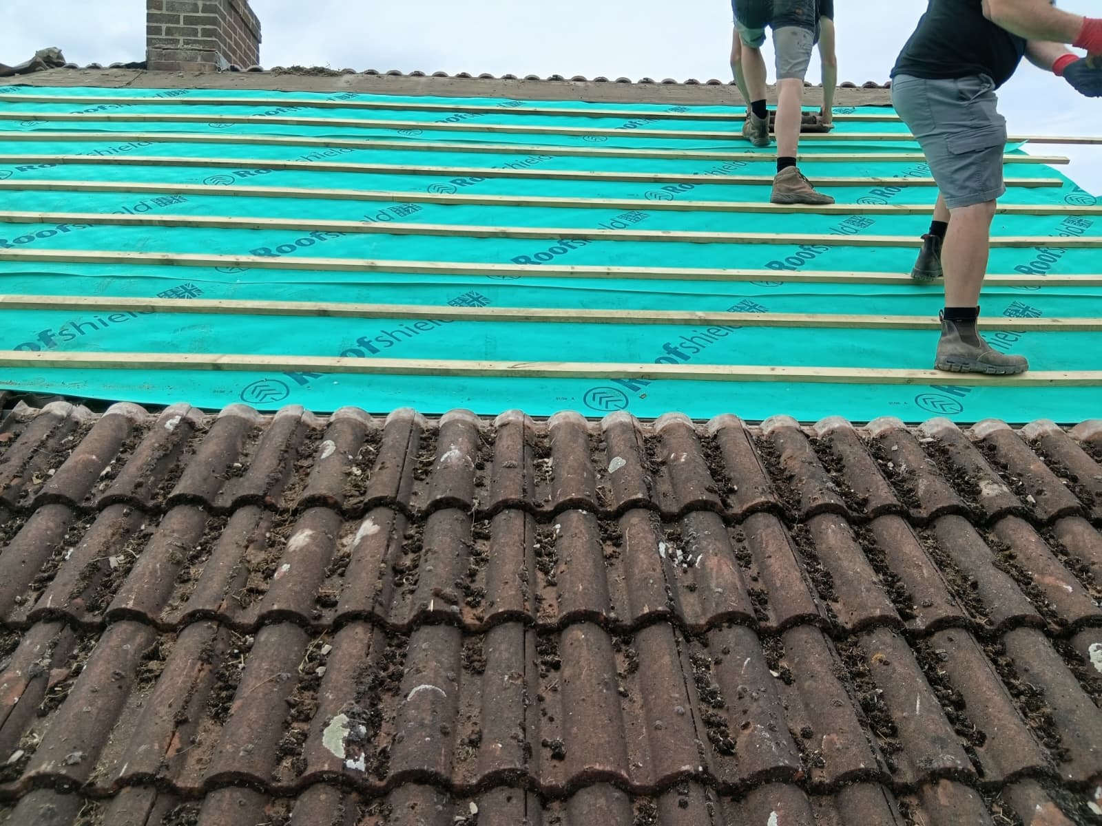 Finished grey tiled roof with new lead flashing and vent pipe installed